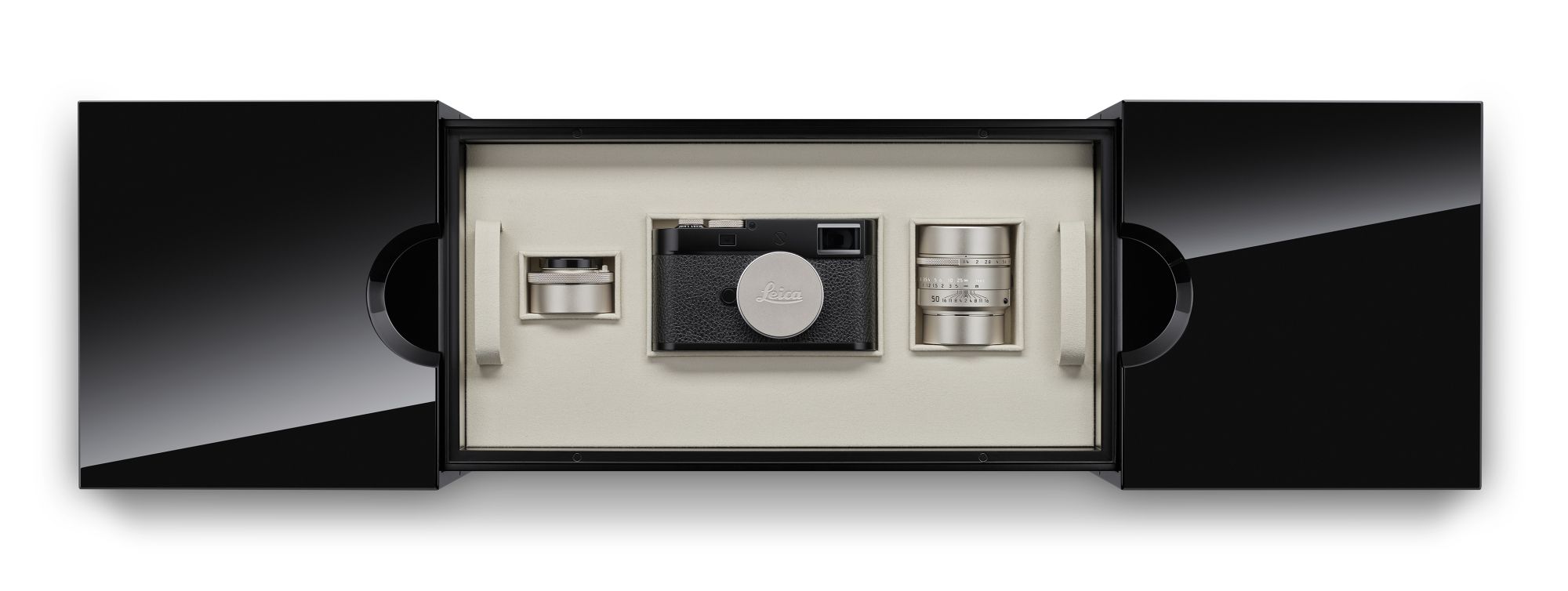 Batch a glossy box with leica camera and two lenses is placed on a white background